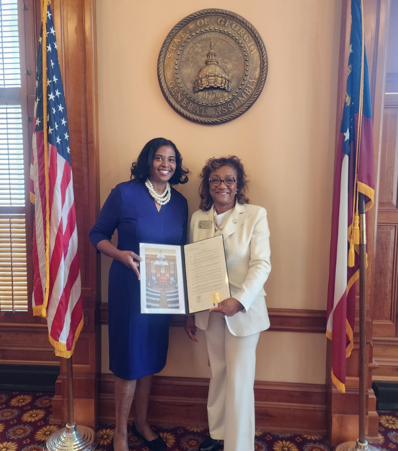 Rep. Karen Bennett, D-Stone Mountain, left, presents a resolution to Karen René in honor of her work as an elected official, public servant, and activist in Georgia.